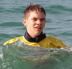 beach surf squats fully clothed in lifeguard anorak cagoule